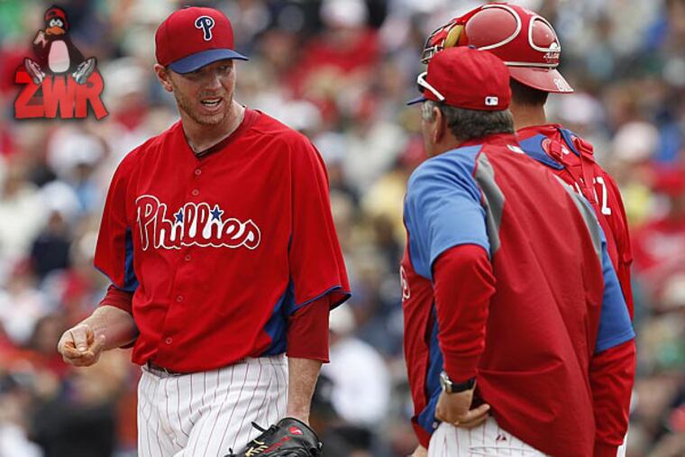 Phillies starting pitcher Roy Halladay talks with pitching coach Rich Dubee. (David Maialetti/Staff Photographer)