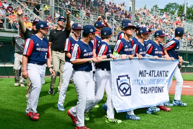 Players and coaches with the East Side Little League in West Chester enter Volunteer Stadium for team introductions during opening ceremonies of the 2026 Little League World Series in South Williamsport on Wednesday.