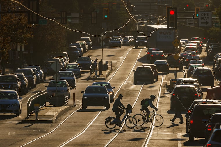 Bicycle commuters cross Girard Avenue during the early morning commute in Philadelphia on a Wednesday in October.