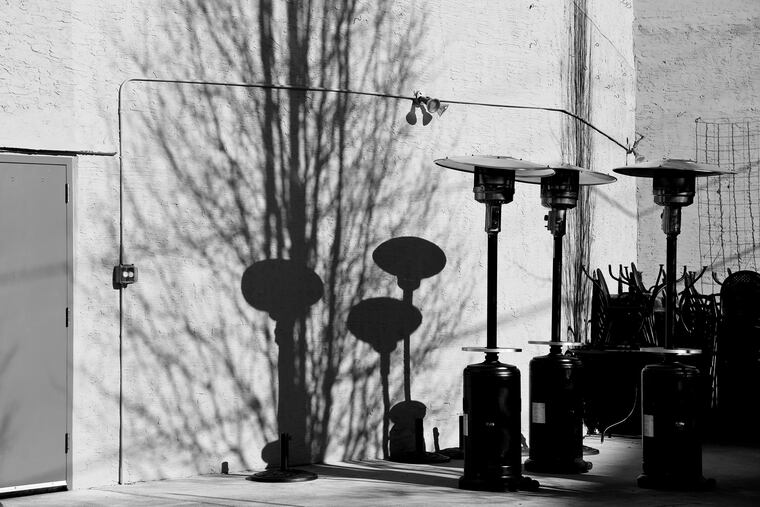 Space heaters and outdoor dining furniture are joined by the shadow of a winter-bare tree, a cold still life along East Passyunk Avenue. This Monday's Weekly column "Scene Through the Lens," staff photographer Tom Gralish’s visual exploration of our region.