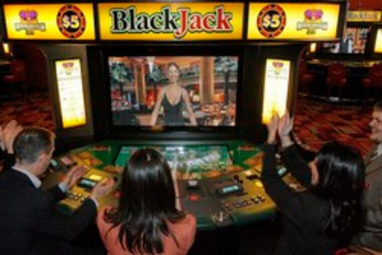 At PhiladelphiaPark Casino in Bensalem, (from left) Kelly Gerrity, Andy Green, Meghan White, Darlene Monzo and Lowell Jacobsen demonstrate one of the new blackjack machines.