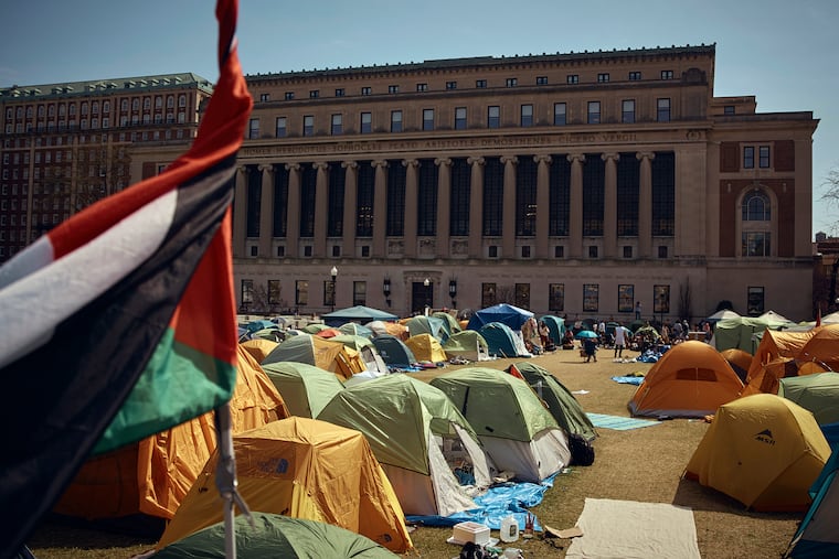 People listen to a speaker during a pro-Palestinian encampment, advocating for financial disclosure and divestment from all companies tied to Israel and calling for a permanent cease-fire in Gaza, inside Columbia University campus on Sunday in New York.