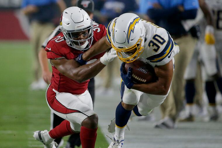 Rudy Ford (left) takes down the Chargers' Austin Ekeler during a preseason game earlier this month.