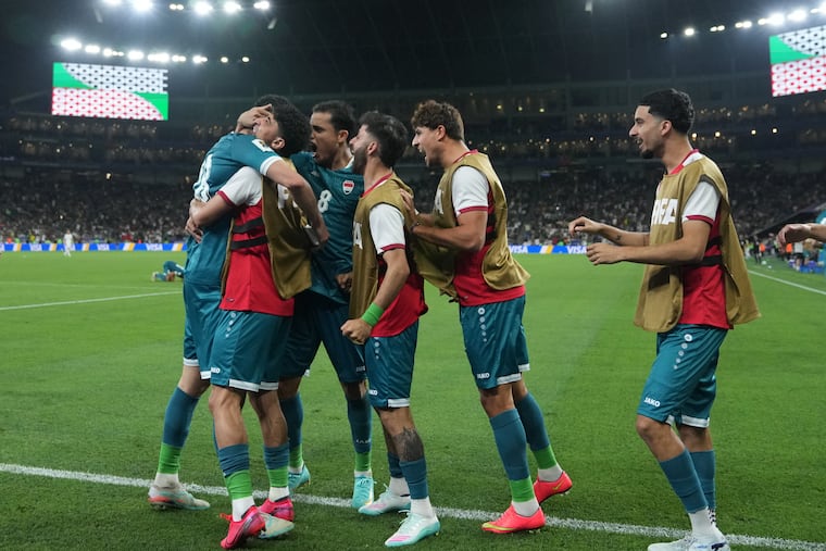 Iraq's Aymen Hussein (far left) is congratulated after scoring his country's second goal during the World Cup playoff final soccer match against Bolivia.