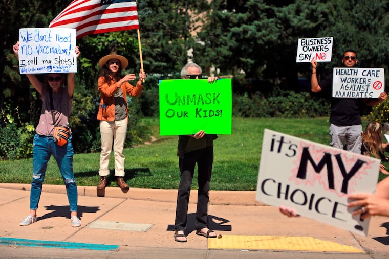 Protesters against COVID-19 vaccine and mask mandates demonstrate near the state Capitol on Friday, Aug. 20, 2021, in Santa Fe, N.M..