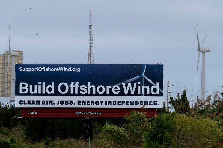 In this Sept. 18, 2024 file photo, a billboard supporting offshore wind power projects sits on a roadside near land-based wind turbines in Atlantic City.