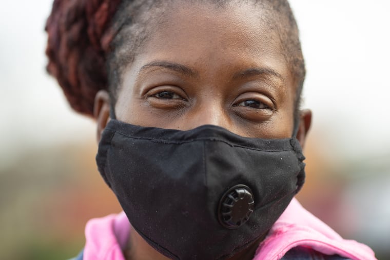 Marian Wilson, of Pennsauken, waits in line with her children for COVID-19 testing in Camden, NJ, on Wednesday, November 25, 2020.