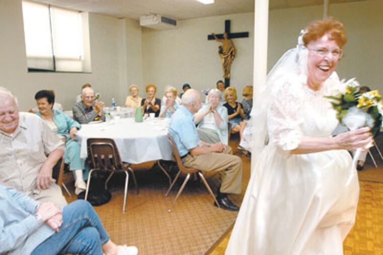 At Queen of Heaven Parish Hall, Dotty Citeroni of Cinnaminson, right, along with other members of a South Jersey troupe called "Girls Again Productions," entertains seniors at lunch time. (April Saul/Inquirer) JCHURCH21P3 105300 3 OF 3