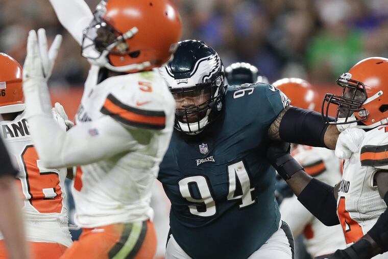 Eagles defensive tackle Haloti Ngata goes after Cleveland Browns quarterback Tyrod Taylor against offensive guard Chris Hubbard during a preseason game at FirstEnergy Stadium in Cleveland on Thursday, August 23, 2018. YONG KIM / Staff Photographer