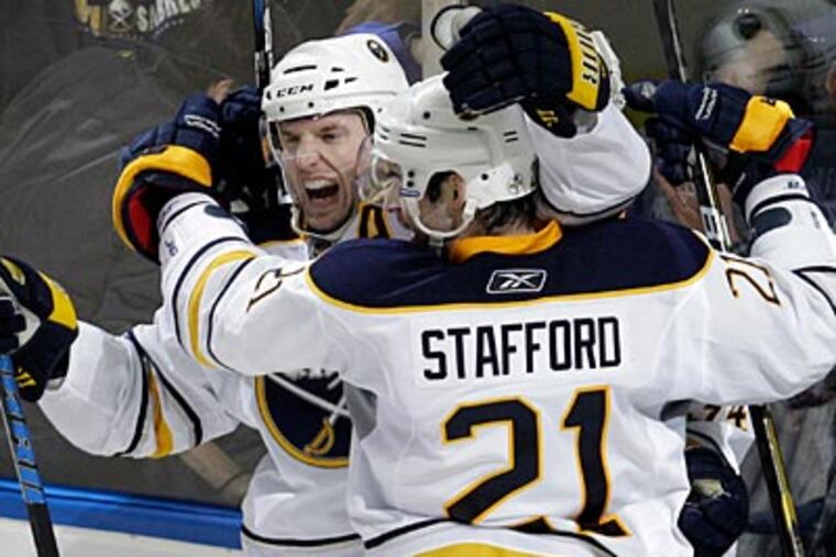 The Sabres' Thomas Vanek, left, celebrates his game-winning goal over the Flyers. (David Duprey/AP Photo)