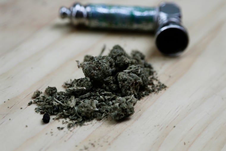FILE - In this June 20, 2018 file photo, marijuana and a pipe used to smoke it . Although there's broad agreement on the idea of legalization, there's no consensus yet on a long list of details that must be figured out before the recreational use of marijuana can be legalized in New Jersey or New York. (AP Photo/Peter Morgan, File)