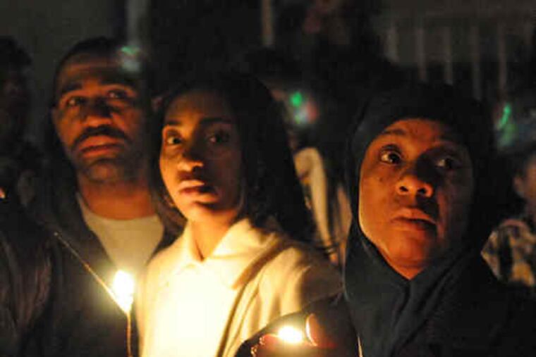 ABOVE: Friends and family gather last night at a candlelight vigil for Tara Brooks.RIGHT: The shooting victim, Tara Brooks (left), with her daughter, Shannon.