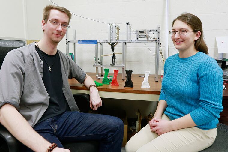 David McDevitt and Kristyn Voegle with the one tenth scale elbow of the Dreadnoughtus in a testing rig.