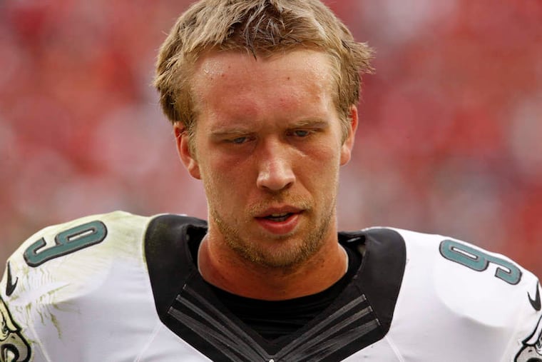 Eagles quarterback Nick Foles, whose season was cut short by injury, did not get a ringing endorsement on his future from owner Jeffrey Lurie or coach Chip Kelly. RON CORTES / Staff