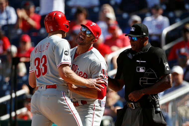 Phillies manager Gabe Kapler, center, holds back Brad Miller as Miller argues with umpire Alan Porter after striking out looking in the sixth inning of the opener of a day-night doubleheader. Miller was ejected from the game after the at-bat.