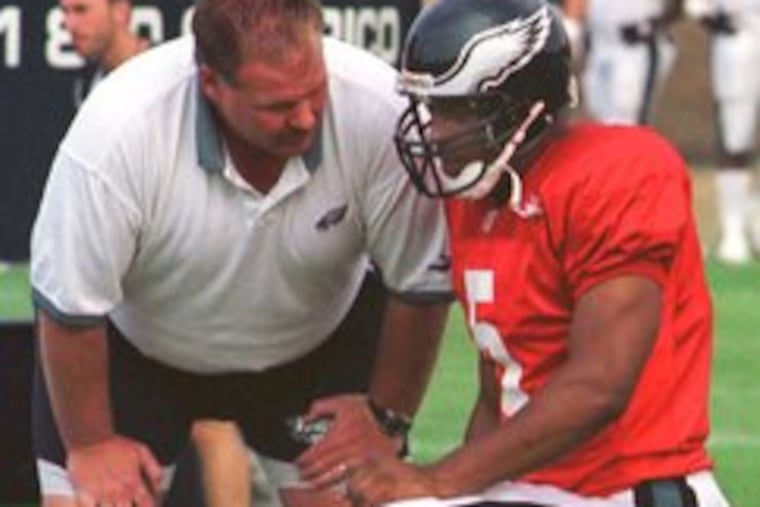 Andy Reid talks to quarterback Donovan McNabb during training camp in 1999, which also was McNabb's first with the Eagles. Reid believes tough times laid a foundation for winning.