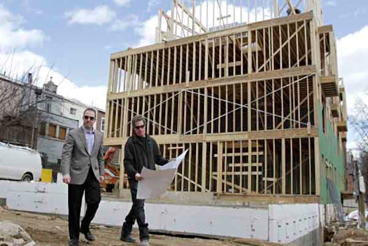 Developers Harvey (lright) and Noah Ostroff (father and son) inspect their project in the 1800 block of Lombard St. in Phila. where they are building 11 new homes on March 14, 2013. ( ELIZABETH ROBERTSON / Staff Photographer )