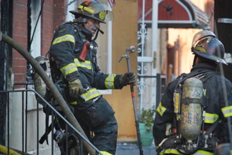Philadelphia fire department was called to 3462 Joyce St. for a middle of the row house fire on Monday morning November 26, 2012. A resident died and another taken to a local hospital in serious condition. ( Alejandro A. Alvarez / Staff)
