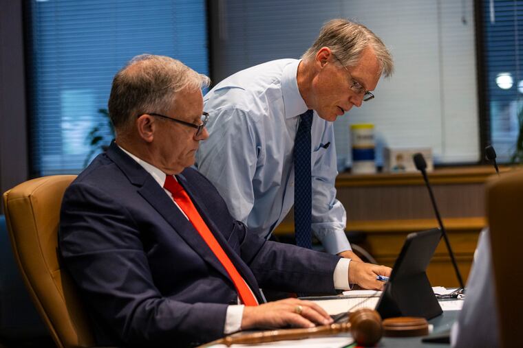 James H. Grossman Jr. (right), the investment chief for the PSERS pension fund, goes over issues with the fund's board chairman, Christopher Santa Maria at a June meeting. Grossman and other members of his investment team recently updated their financial disclosures.