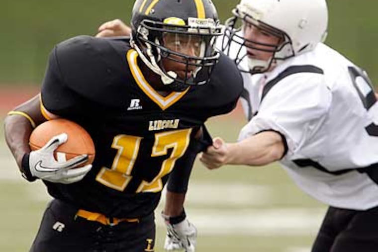Lincoln's James Baldered, left, breaks free from a tackle by Southern's Joseph Pizzo, right. (David Maialetti/Staff Photographer)