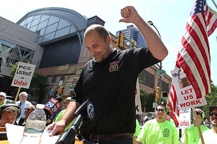 James Hocker, a member of the Metropolitan Regional Council of Carpenters, left, reacts to the support from union members.