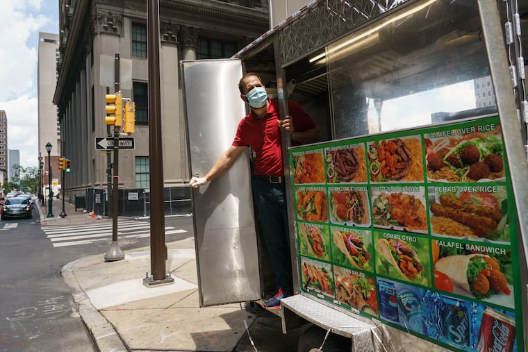 Momin Mohiby working at his gyro cart at 17th and Arch Streets.