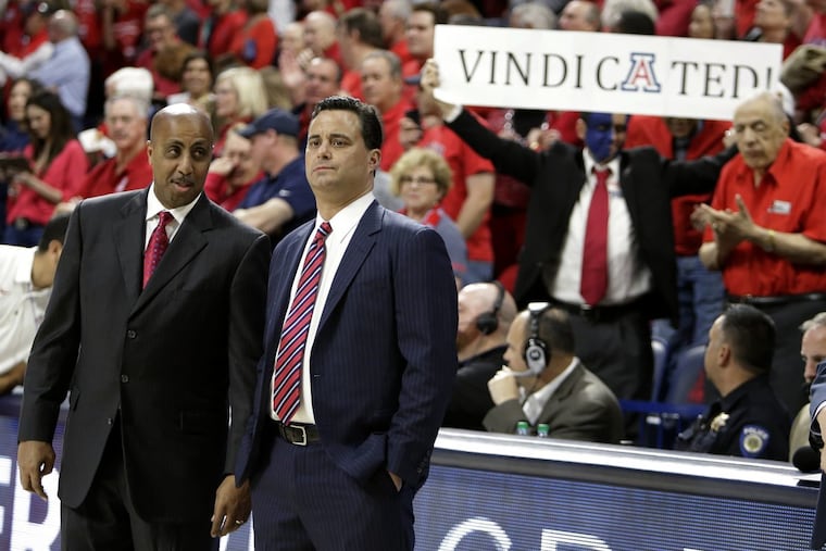 Arizona associate head coach Lorenzo Romar, left, and head coach Sean Miller talking before Thursday night’s game.
