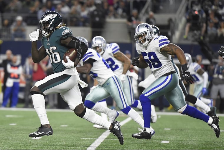 Jay Ajayi, left, leaves a host of Cowboys defenders in his dust during a third-quarter run Sunday night.