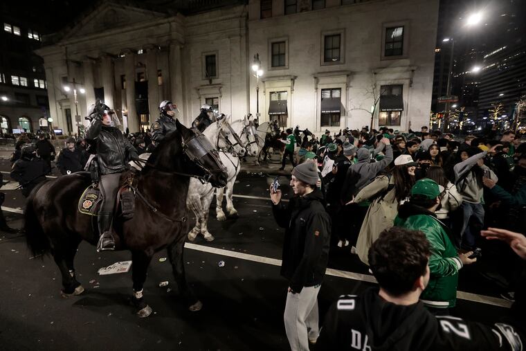 Police on horseback attempt to push celebrating Eagles fans out of Center City after the Super Bowl game between the Philadelphia Eagles and Kansas City Chiefs on Sunday.