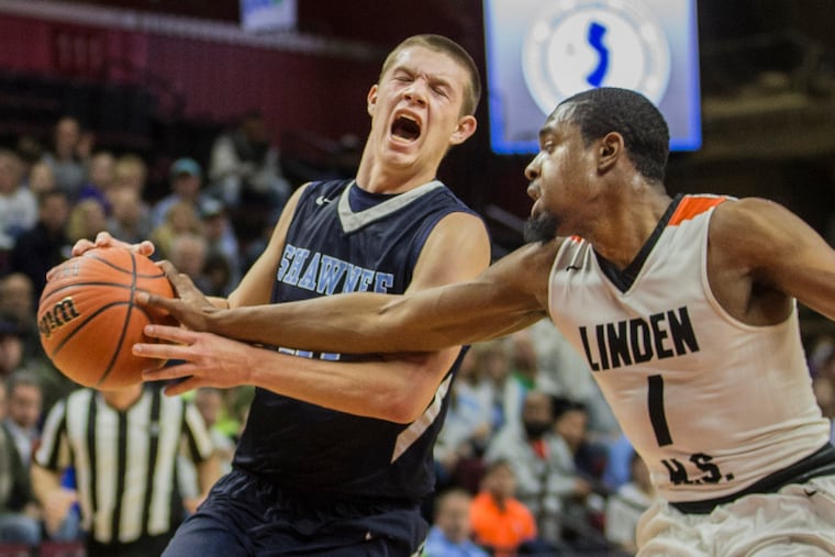 Shawnee's No. 31, Dean Noll, left, reacts to Linden's Khalief Crawford's attempt to steal the ball as Noll was bringing it down the floor in the second quarter.