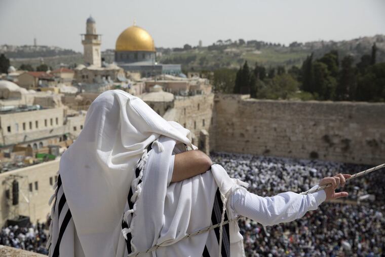 Jewish men of the Cohanim priestly caste participate in a blessing during the Passover holiday, in front of the Western Wall, the holiest site where Jews can pray in Jerusalem’s Old City. U.S. officials say President Donald Trump will recognize Jerusalem as Israel’s capital. His decision could have deep repercussions across the region.