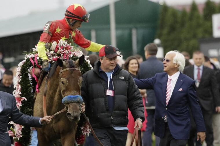 Bob Baffert (right) celebrates with jockey Mike Smith after Smith rode Abel Tasman to victory in the Kentucky Oaks in May.