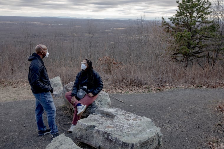 Jeanine Hays and husband Bryan Mason on a hiking trail in Napanoch, N.Y. Because her long covid has many symptoms, they take precautions like wearing N95 masks outside. MUST CREDIT: Yehyun Kim for The Washington Post