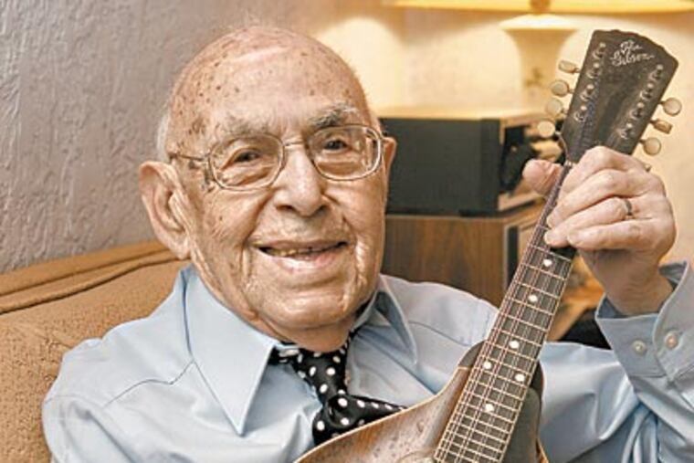 Frank Semola, who turns 105 today, plays his beloved mandolin in his Gloucester County home. He stopped driving only four years ago and still lives independently in the house he built in 1956. (AKIRA SUWA / Staff Photographer)