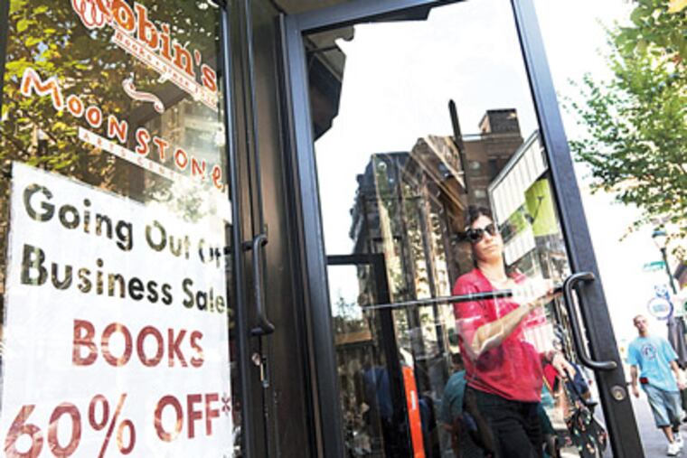 A shopper leaves Robin’s, where readers find both books and camaraderie. RYAN S. GREENBERG / Staff