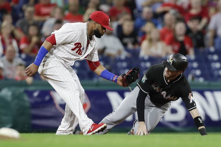 Carlos Santana tags the Marlins' JT Riddle out during a steal attempt on Sept. 15.
