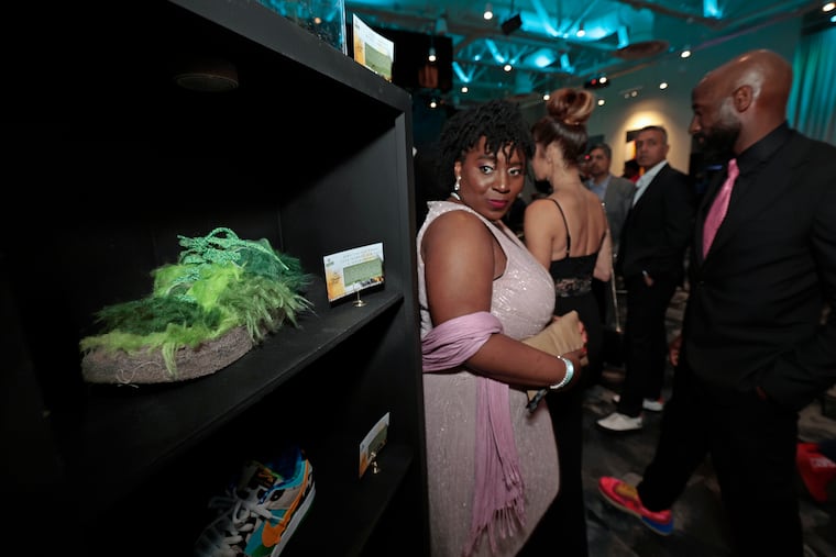 Pennsylvania House of Representatives Speaker Joanna McClinton (right) looks at the Nike Cactus Plant Flea Market Air Flea 1” Overgrown sneaker on display during Change Our Future’s fifth annual Sneaker Ball on Friday at Live! Casino & Hotel Philadelphia.