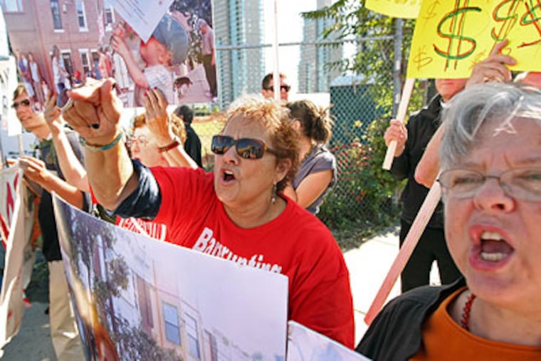 Andrea Preis, of Queen Village, yelled "Shame on You" at every car that pulled into the parking area for the Sugarhouse Casino groundbreaking on Thursday. (Michael Bryant / Staff Photographer)