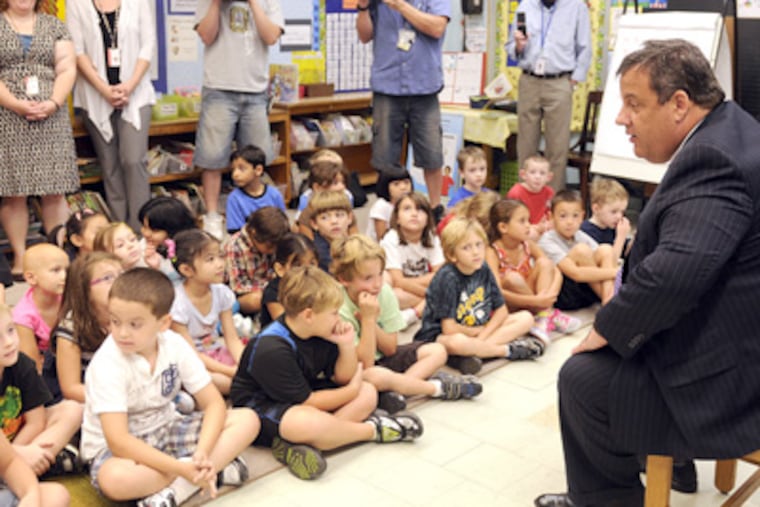 Gov. Christie talking to first graders on Tuesday in the classroom of teachers Sarah Anderson (rear, right) and Kathy Gilmour (rear, left) at Sharp Elementary School in Cherry Hill. (Tom Gralish / Staff Photographer)