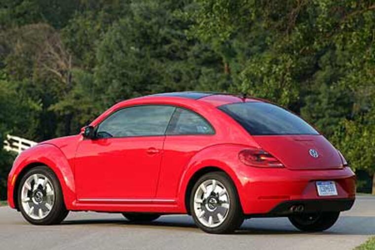 The 2012 VW Beetle. Its dash panel, shorter dashboard, and more-upright windshield hark back to the original.