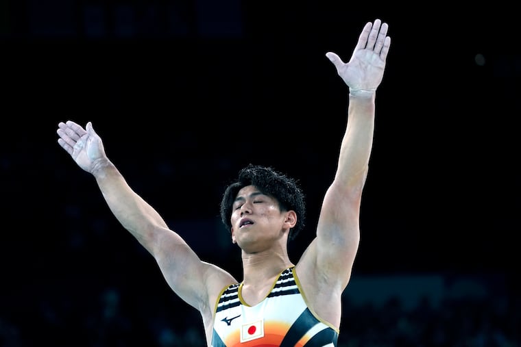 Daiki Hashimoto, of Japan, celebrates after performing on the pommel horse during the men's artistic gymnastics team finals round at Bercy Arena at the 2024 Summer Olympics in Paris.