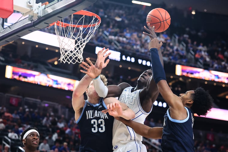 BYU forward Keba Keita (center) goes for a rebound against Villanova forward Matt Hodge (33) and guard Malachi Palmer (right) during the first half of Monday night's opener.