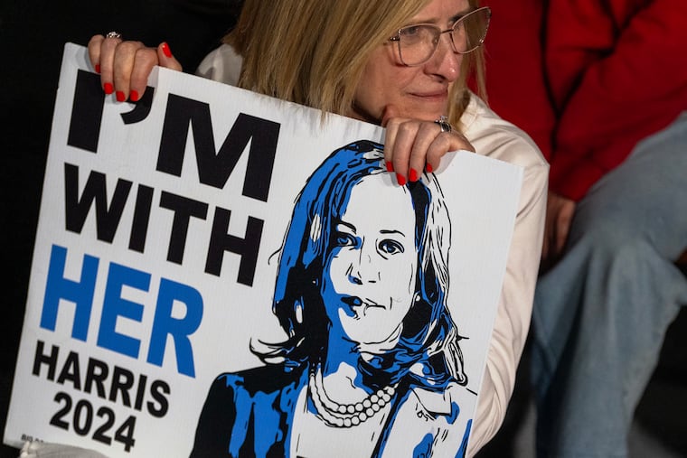 A supporter waits for Vice President Kamala Harris to arrive.