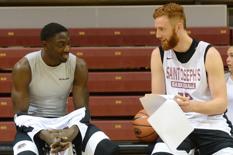 St. Joseph’s University basketball players Markell Lodge and Anthony Longpre chat during St. Joseph's University basketball media day Thursday, November 02, 2017 at Hagan Arena in Philadelphia, Pennsylvania. (WILLIAM THOMAS CAIN / For The Philadelphia Inquirer)