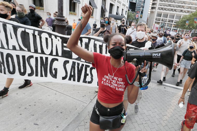 Yahne Ndgo uses the bullhorn as the group marches from City Hall during a "Stop the Sweep" protest that began at City Hall and ended in front of Mayor Jim Kenney's residence in Old City on Sunday night.