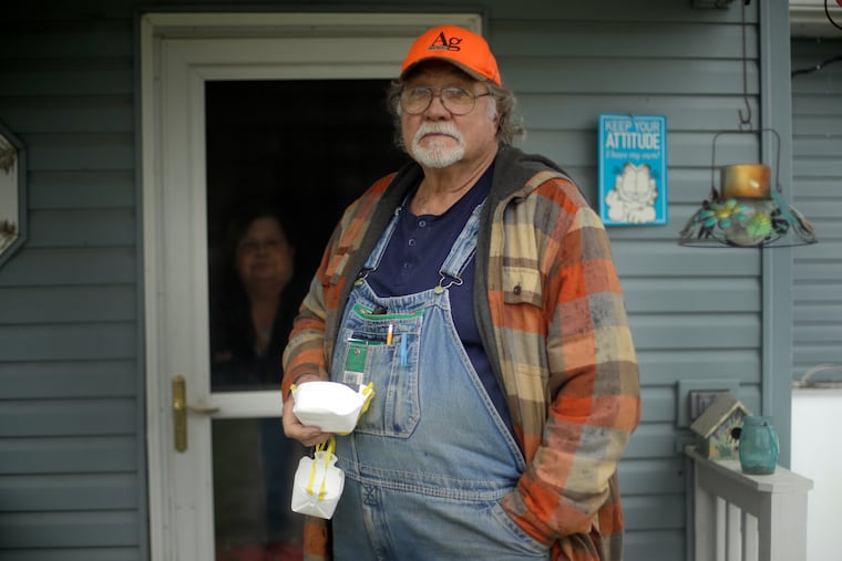 Dennis Ruhnke holds two of his remaining N-95 masks as he stands with his wife, Sharon at their home near Troy, Kan. Friday, April 24, 2020. Dennis, a retired farmer, shipped one of the couple's five masks left over from his farming days to New York Gov. Andrew Cuomo for use by a doctor or a nurse.