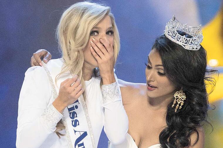 Miss New York Kira Kazantsev wins the title of Miss America on Sunday, Sept. 14, 2014, and receives her sash from outgoing Miss America Nina Davuluri. ( ED HILLE / Staff Photographer )