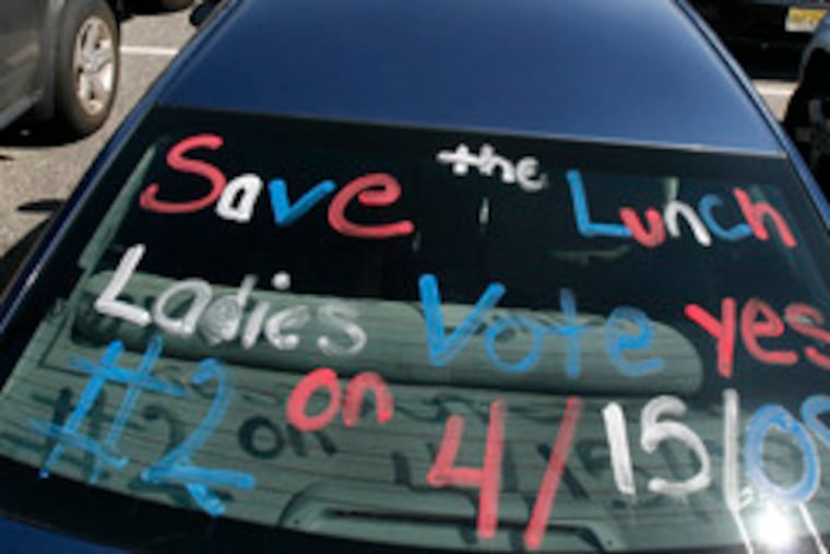 Lunch Lady Pat Garofalo uses her car to plead for yes votes on the question of funding for the district food-service department.