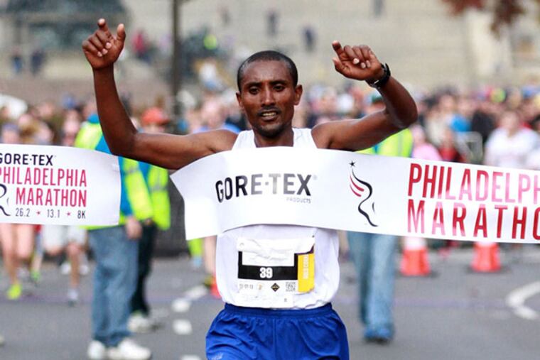 Abebe Dagne Mekuriya of Ethiopia, with an unofficial time of 2:17:43, is the first man to cross the finish line of the Philadelphia Marathon November 17, 2013