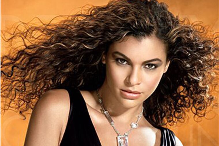 This photo released by Mizani shows a model with Type III - Wavy Hair, on the MIZANI Natural Curl Key, S -Shaped Curls with uniform wave patterns.